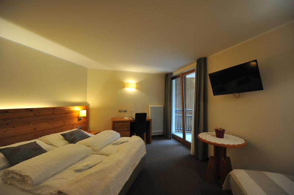 Postel nebo postele na pokoji v ubytování Bio Hotel Brusago Vital & Wellness