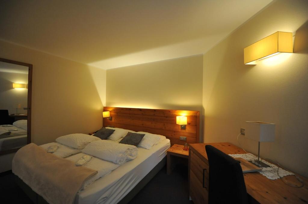 Postel nebo postele na pokoji v ubytování Bio Hotel Brusago Vital & Wellness