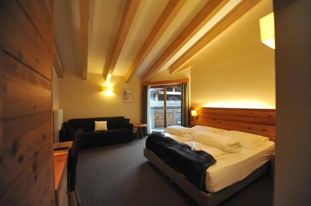 Postel nebo postele na pokoji v ubytování Bio Hotel Brusago Vital & Wellness