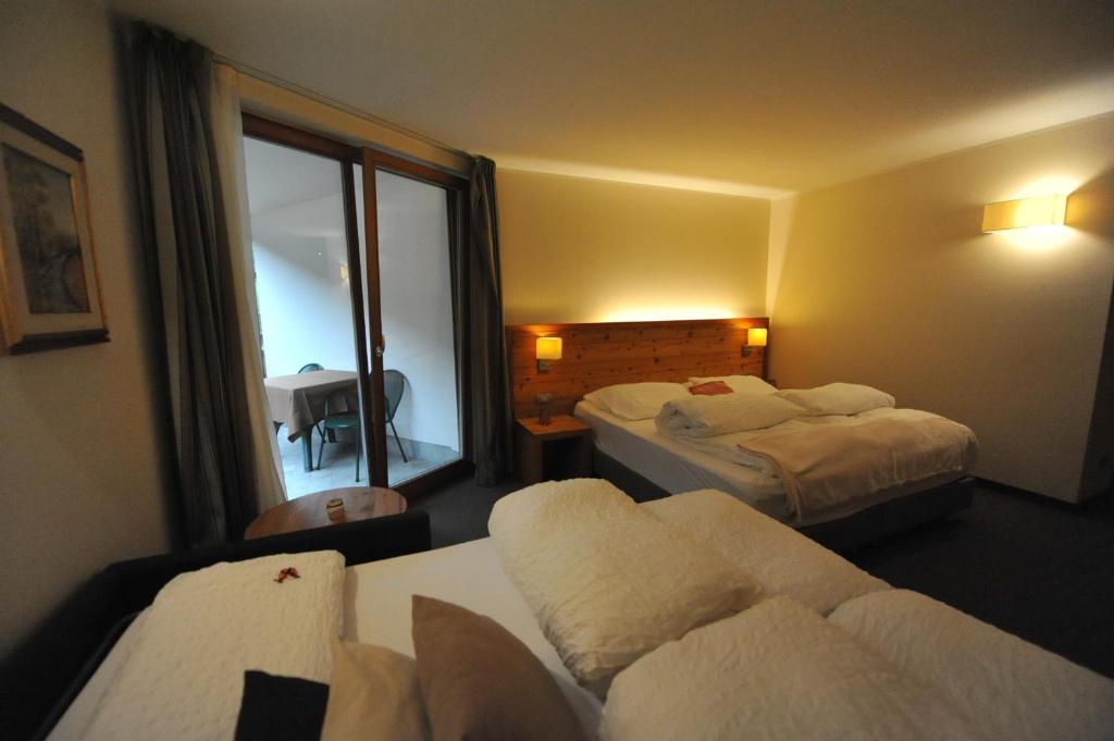 Postel nebo postele na pokoji v ubytování Bio Hotel Brusago Vital & Wellness