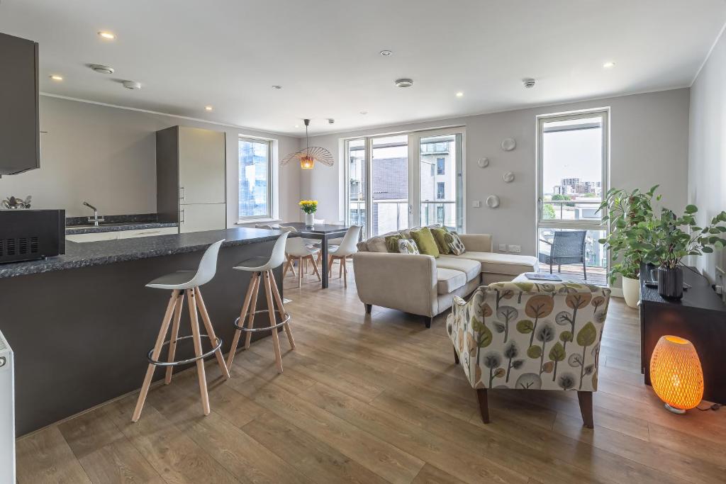 a kitchen and living room with a couch and a table at Lovely 3 beds Penthouse in London