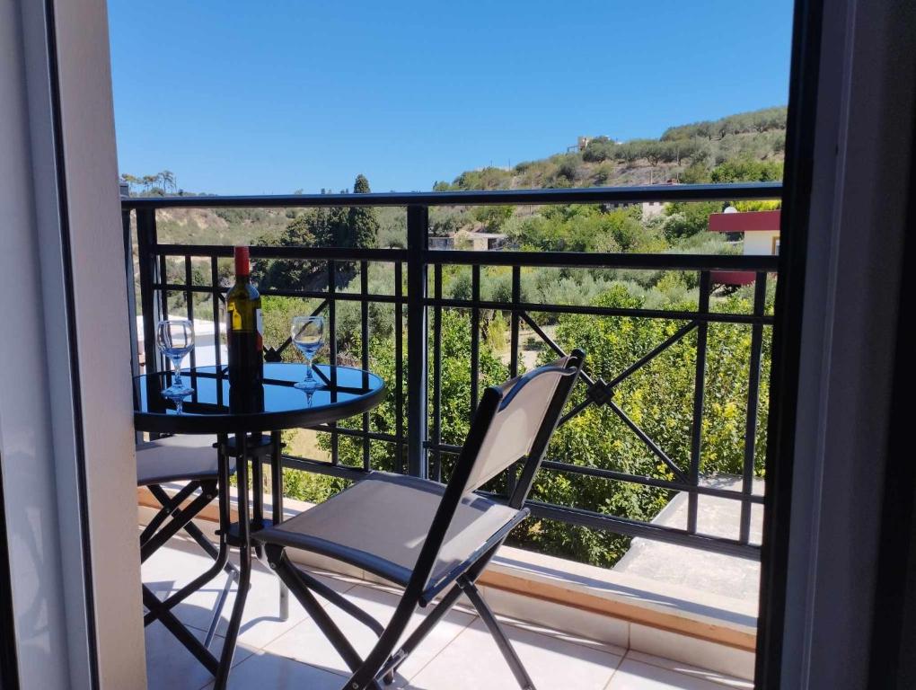 a balcony with a table and chairs and a view at Istamos apartment in Stamnoí