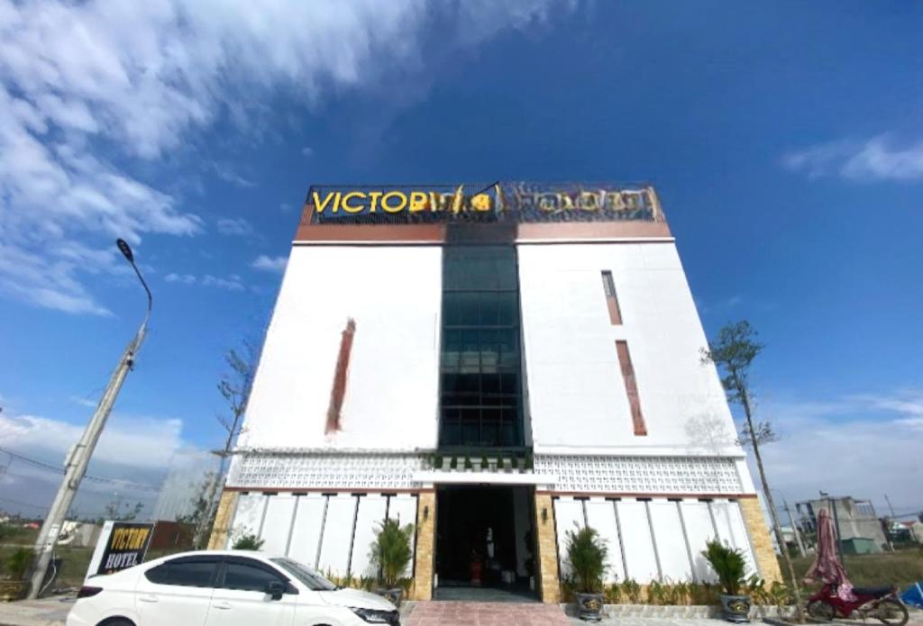 a white car parked in front of a building at OYO 1192 Victory Hotel Dien Ban in Danang