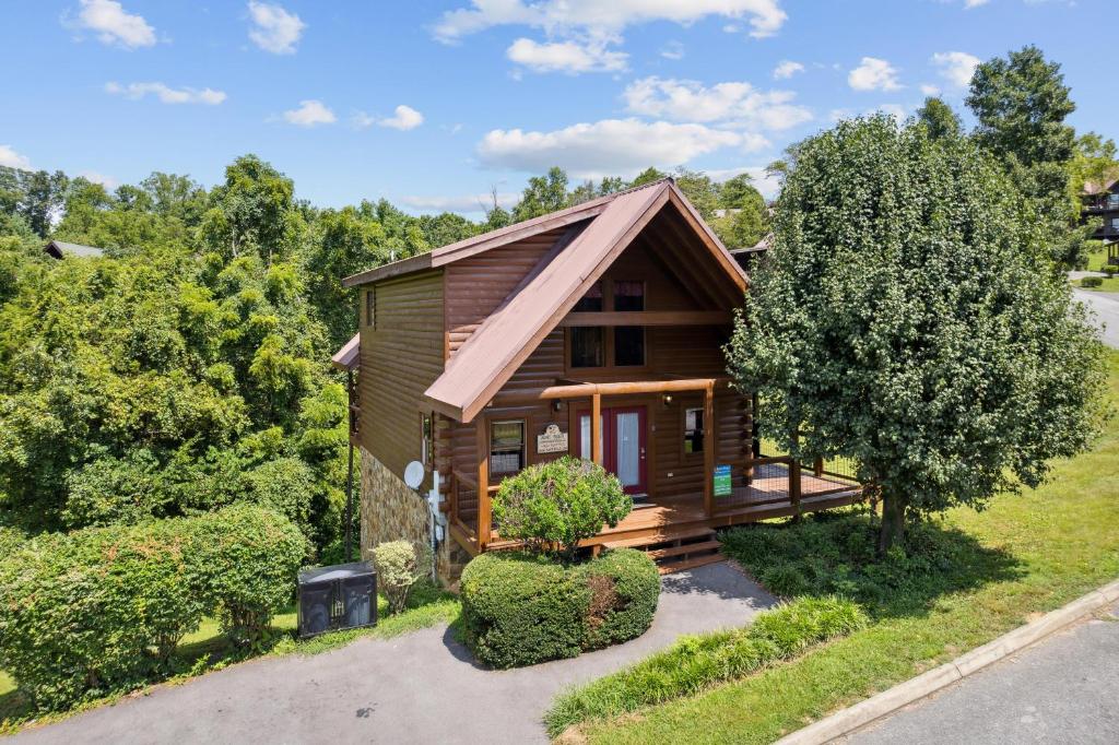 a cabin in the woods with a tree at Amazing Grace #264 in Pigeon Forge