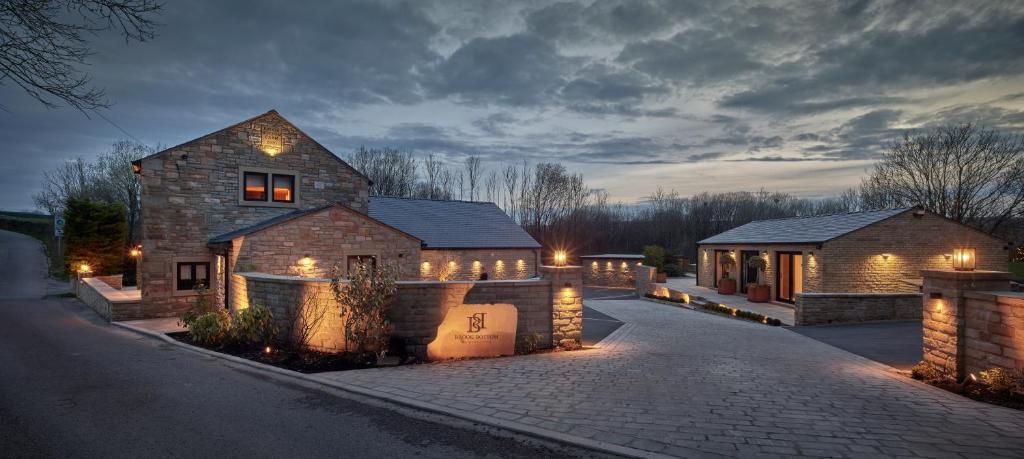 a house with lights on a driveway at night at Apartments for two in Brand New Luxury Rural Farmhouse Escape in Ramsbottom