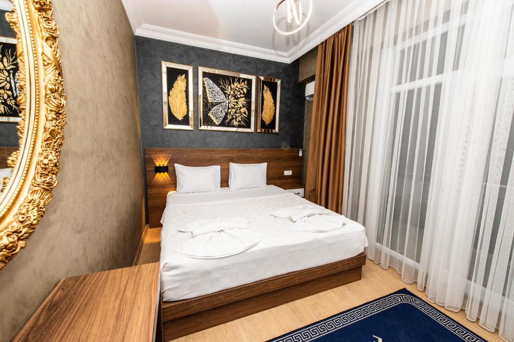 a bedroom with a bed and a mirror at Blue Vista Hotel & SPA in Esenyurt