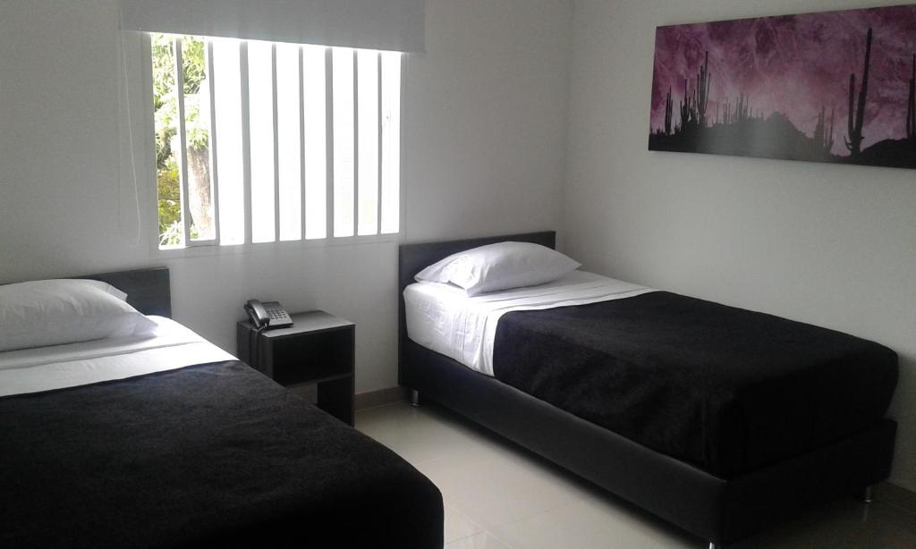 Postel nebo postele na pokoji v ubytování Hotel Onix T