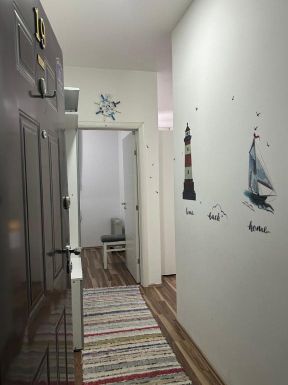 a hallway with a staircase with a lighthouse on the wall at Adam's Apartment 2 in Kladovo