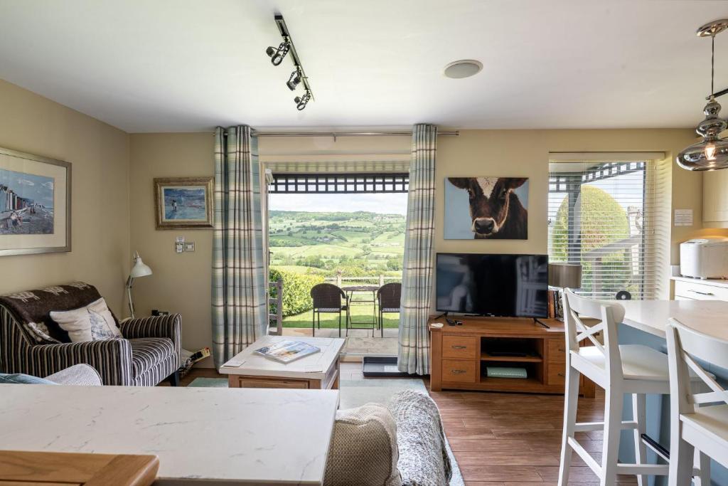 a living room with a couch and a tv at Primrose Retreat in Whitby