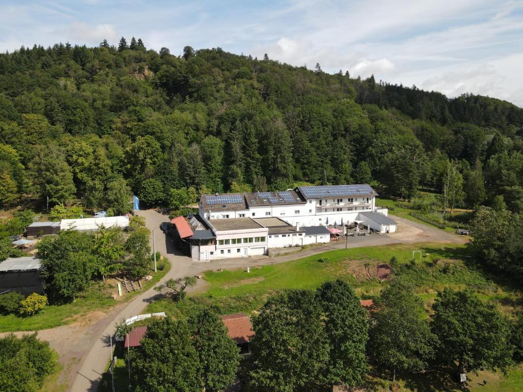 une vue aérienne d'un bâtiment au milieu d'une montagne dans l'établissement Hotel Restaurant Litermont, à Nalbach