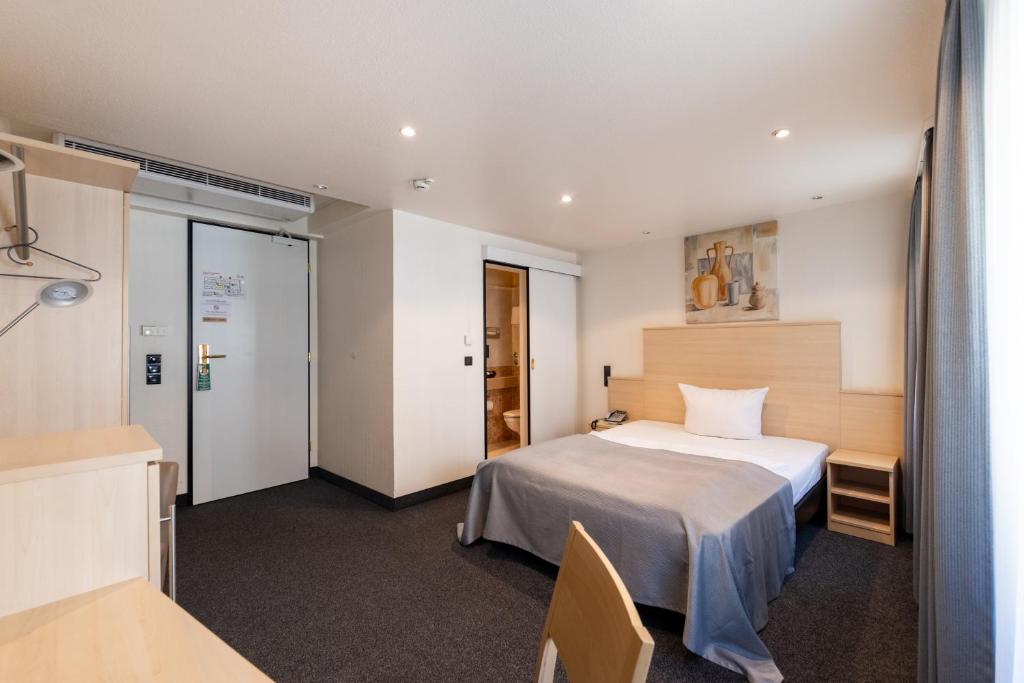 Postel nebo postele na pokoji v ubytování Hotel Ross
