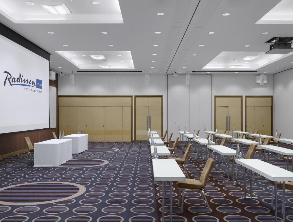 a lecture room with rows of tables and a screen at Radisson Blu Waterfront Hotel, Jersey in Saint Helier Jersey