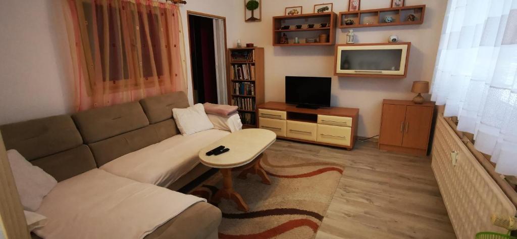 a living room with a couch and a table at Zrekonštruovaný byt s výhľadom na tichom mieste in Púchov