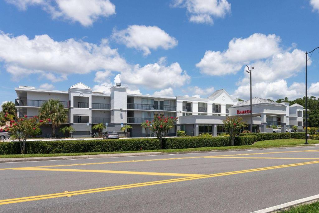 a large white building on the side of a street at Ramada by Wyndham Altamonte Springs Near I-4 in Orlando