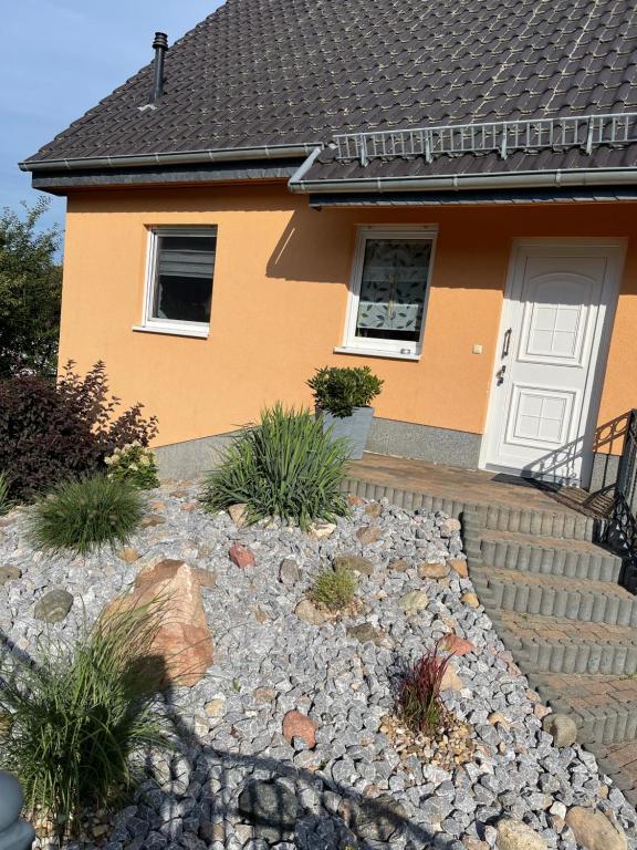 a house with a rock garden in front of it at Oase der Ruhe 2 in Waldsieversdorf