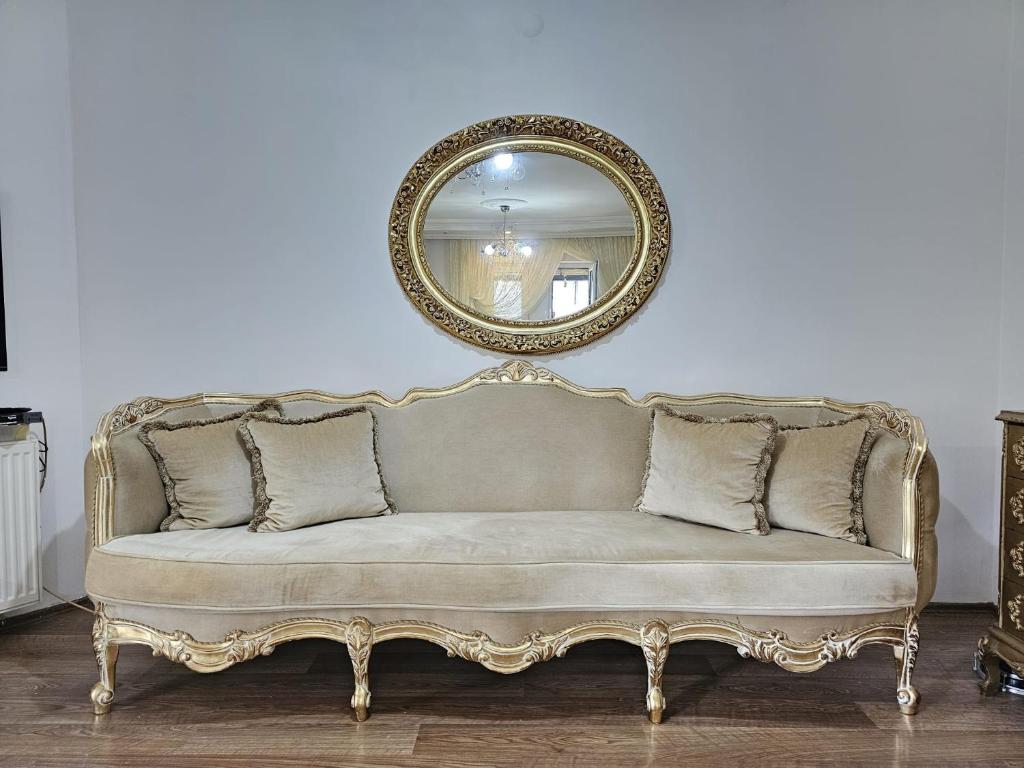 a couch in a room with a mirror at Villa surrounded by nature in Kireçhane