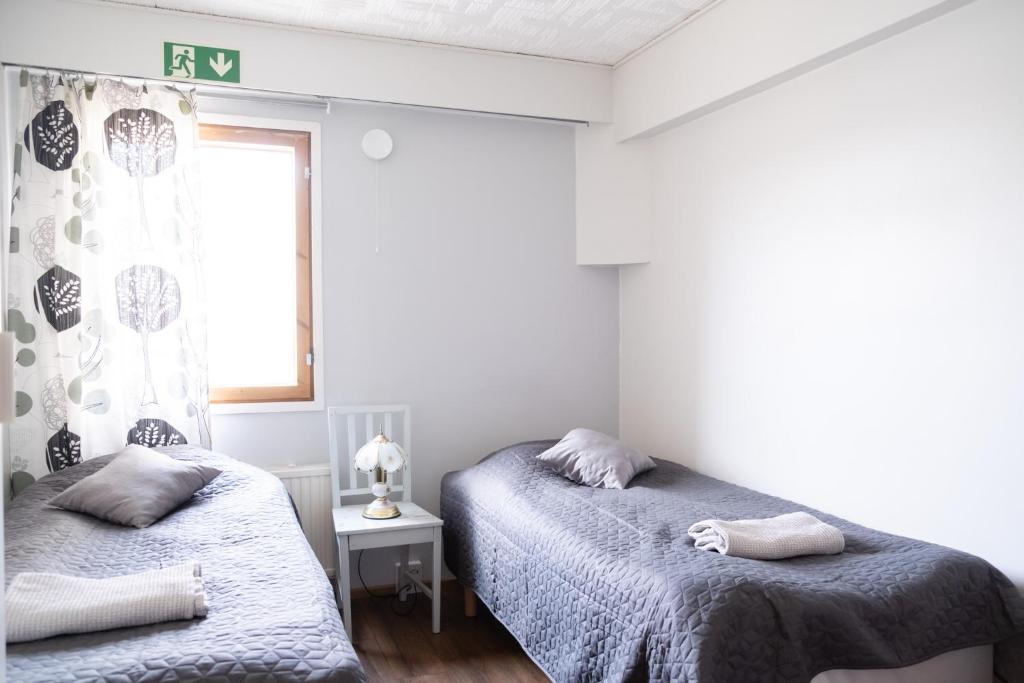 Postel nebo postele na pokoji v ubytování Bed & Breakfast Restaurang Sybarit