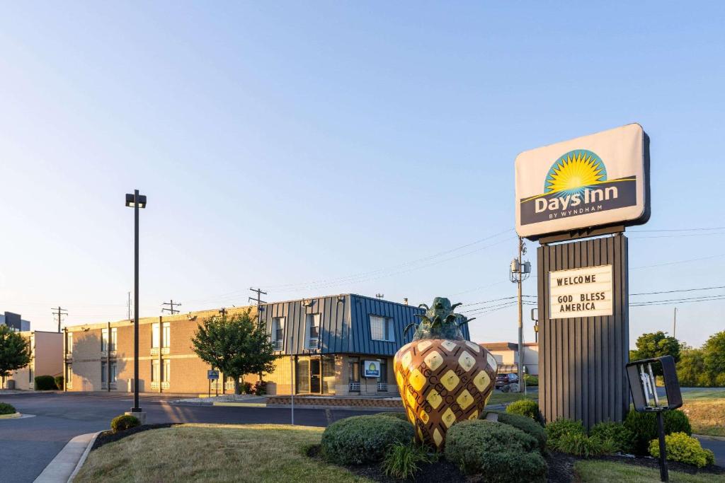 a sign for aldrin inn in front of a building at Days Inn by Wyndham Winchester in Winchester