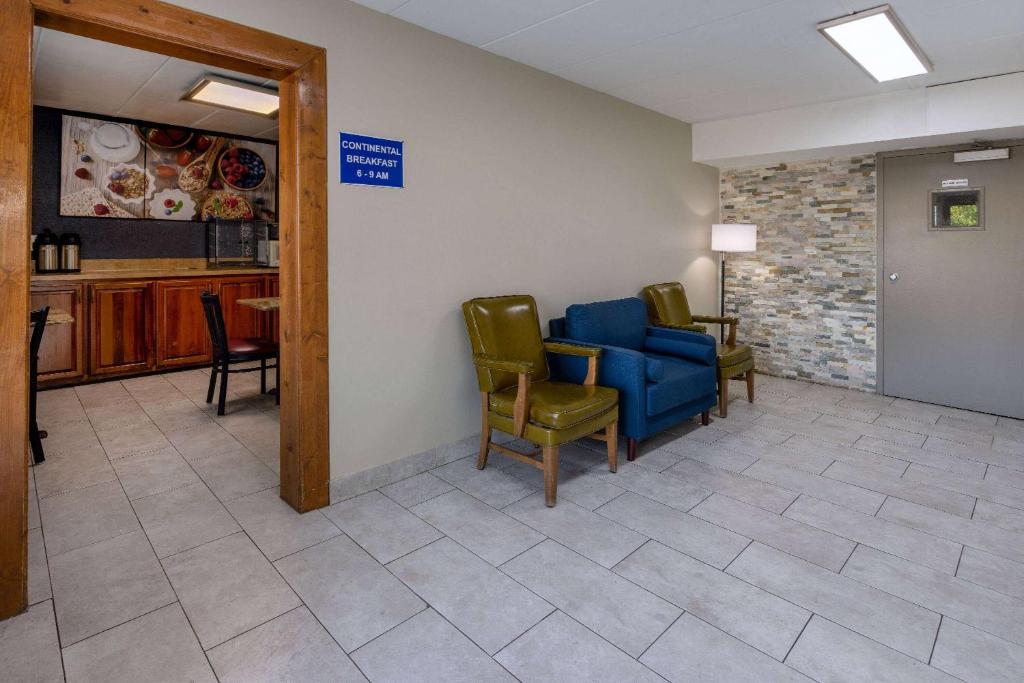 a waiting room with a blue couch and chairs at Days Inn by Wyndham Winchester in Winchester