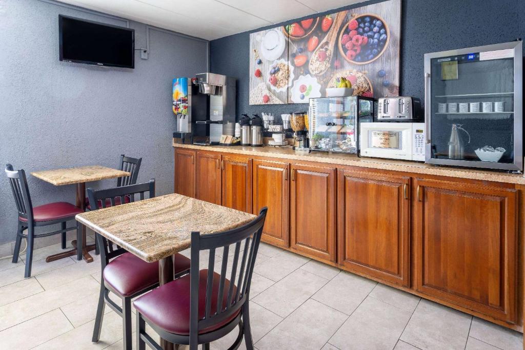 a restaurant with two tables and a counter with a coffee shop at Days Inn by Wyndham Winchester in Winchester