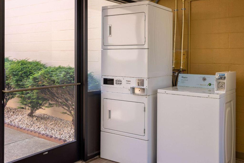 a white refrigerator sitting next to a window at Days Inn by Wyndham Winchester in Winchester