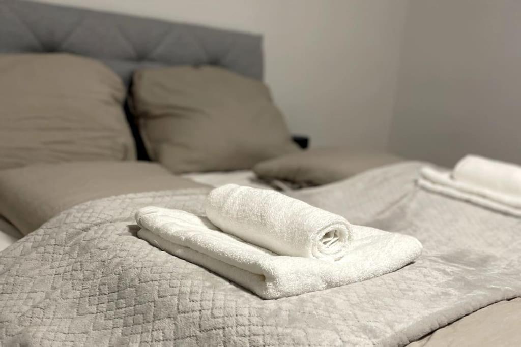 a white towel sitting on top of a bed at StayQuality Apartments Vienna #1 in Vienna