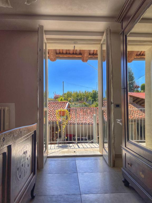 an open door to a balcony with a view at Cà di Gat in La Morra
