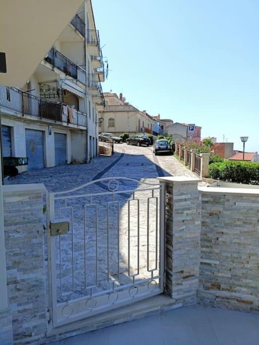 a gate to a building with a street behind it at Stanza Mylai Etna View in Castelmola