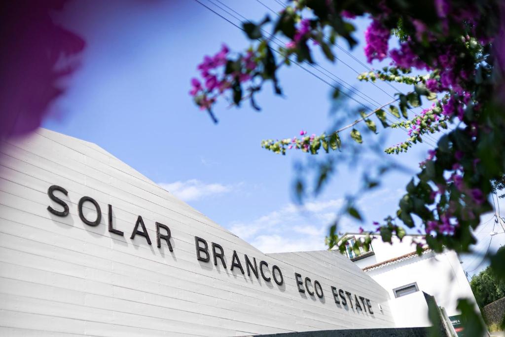 a sign for a solar braiding company on a building at Solar Branco Eco Estate in Ponta Delgada