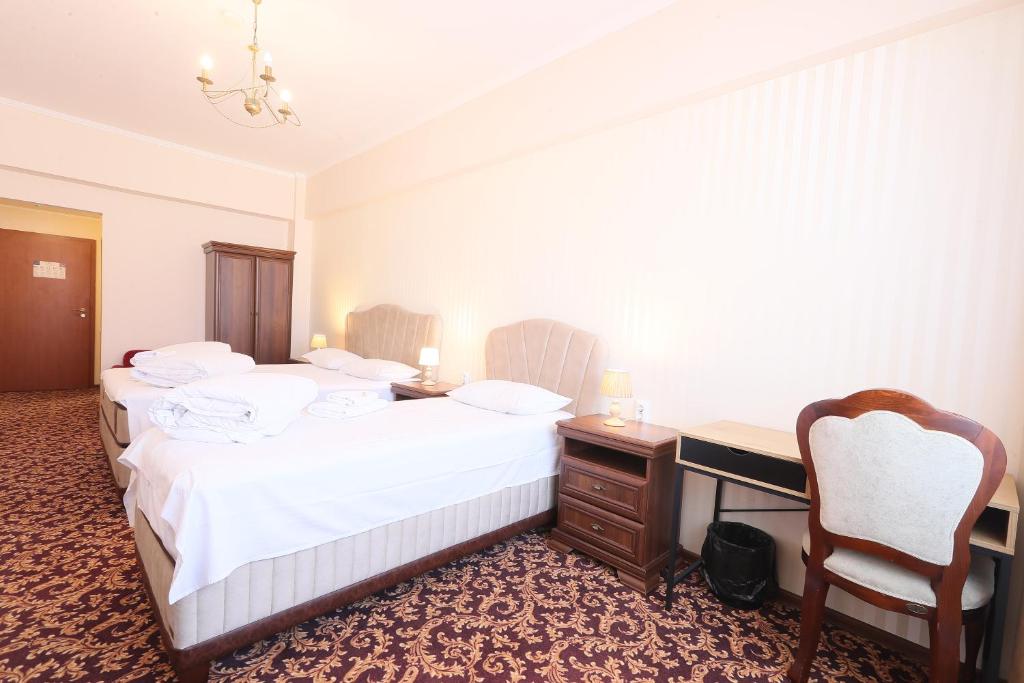 Postel nebo postele na pokoji v ubytování Hotel Impero