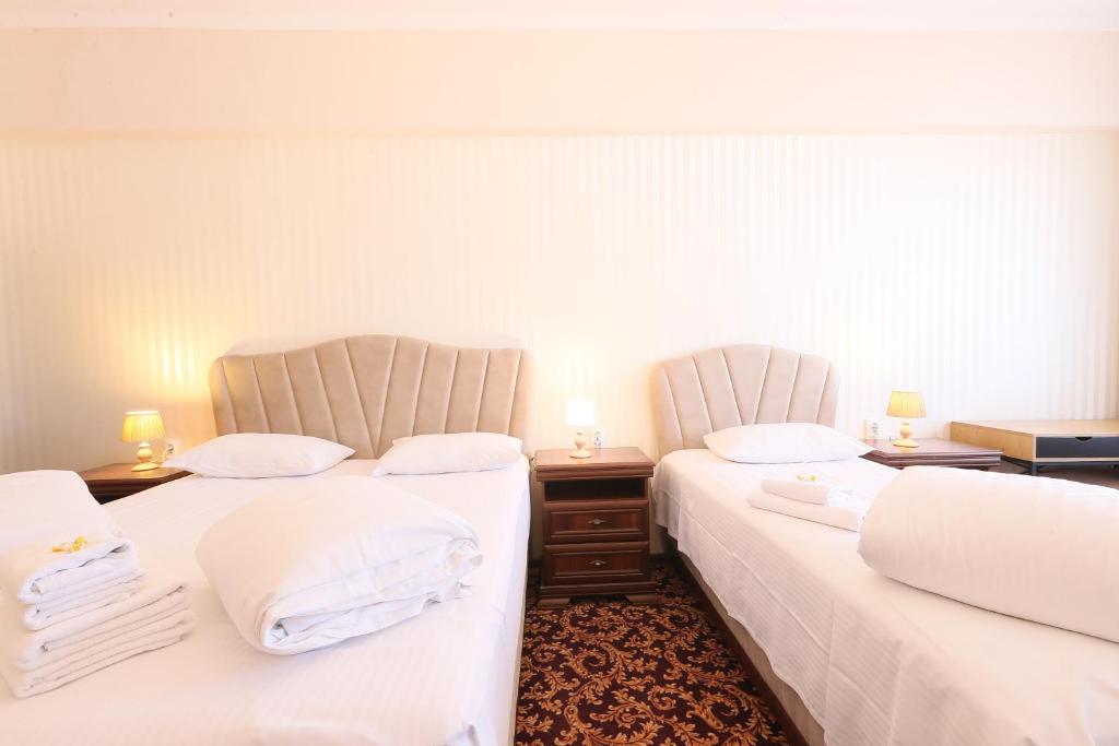 Postel nebo postele na pokoji v ubytování Hotel Impero