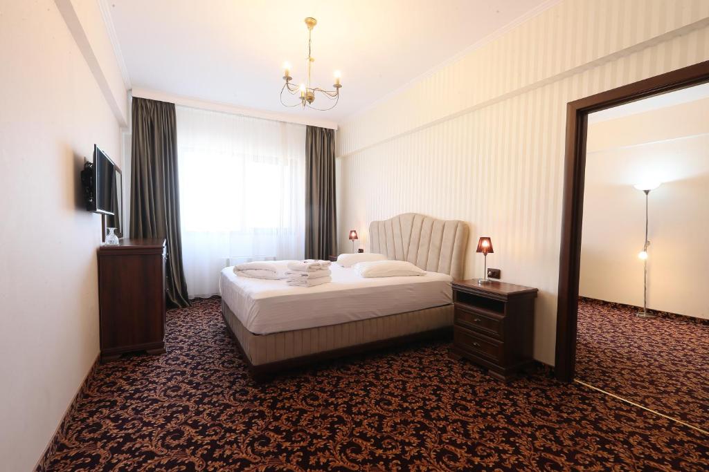Postel nebo postele na pokoji v ubytování Hotel Impero