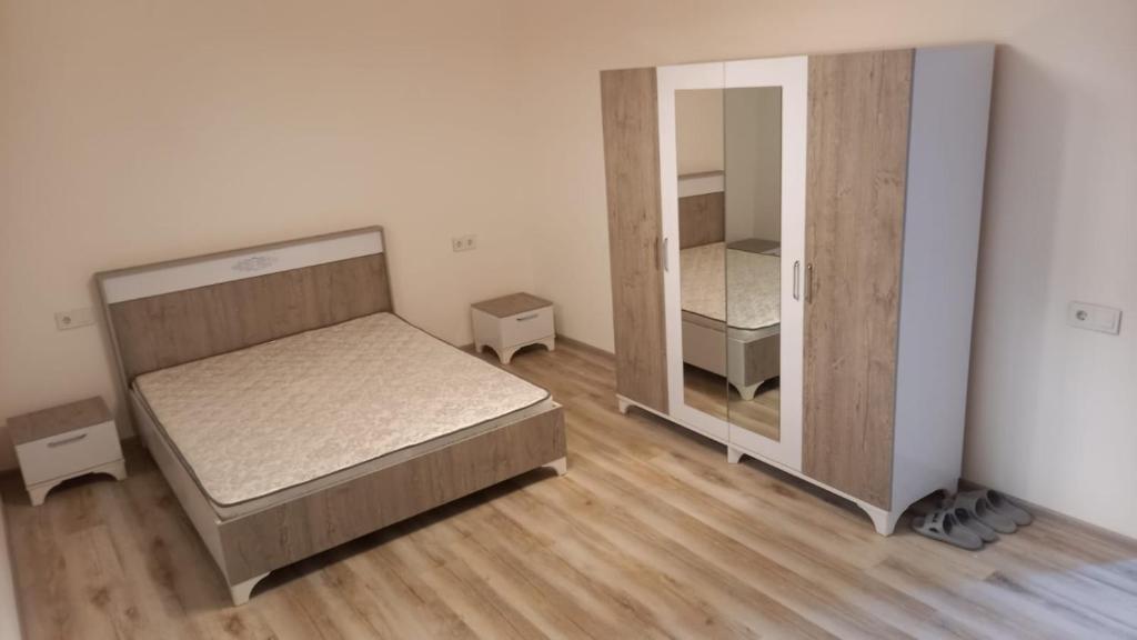 a bedroom with two beds and a mirror at İsmayilov's-Lahij hotel in İsmayıllı