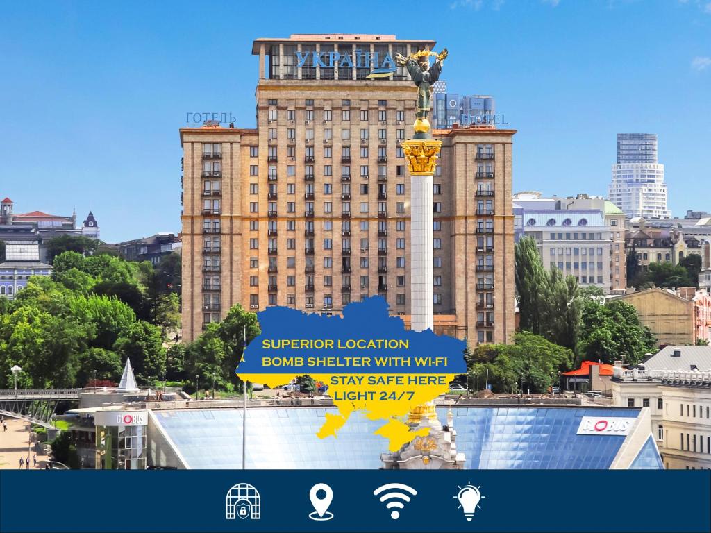 a large building with a sign in front of it at Ukraine Hotel in Kyiv