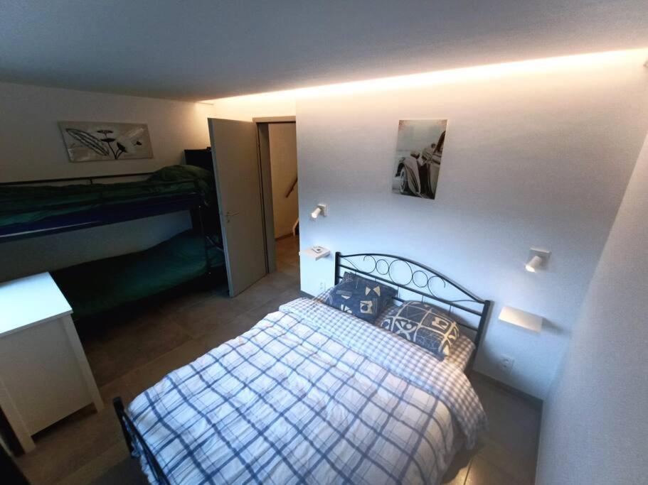 a small bedroom with a bed in a room at Le Havre du Circuit / Triplex avec Sauna in Malmedy