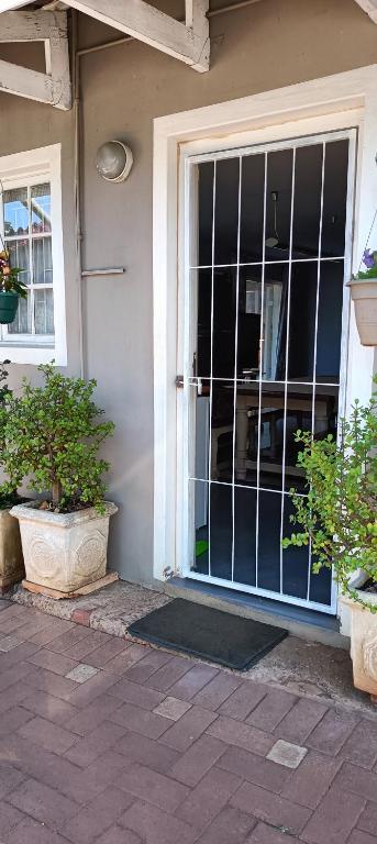 a front door of a house with a window at Wylie Hall Guesthouse in Durban