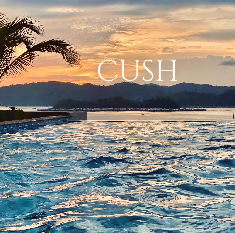 a sunset over the water with the words guest at CUSH @ Jesselton Quay Seaview in Kota Kinabalu