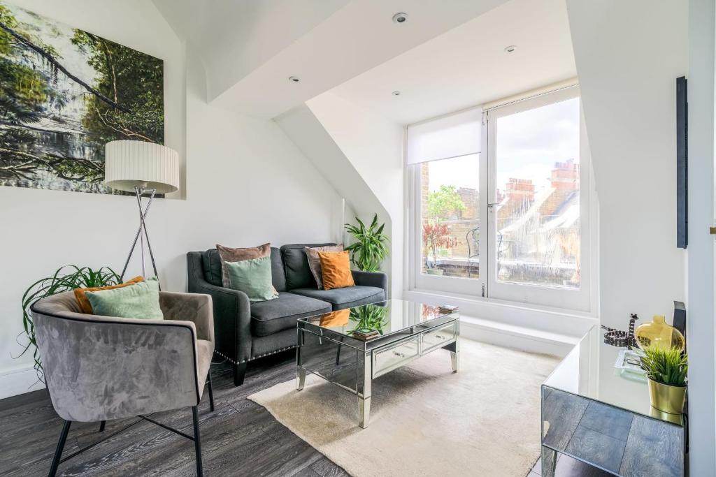 a living room with a couch and a table at Gorgeous Hampstead Flat in London