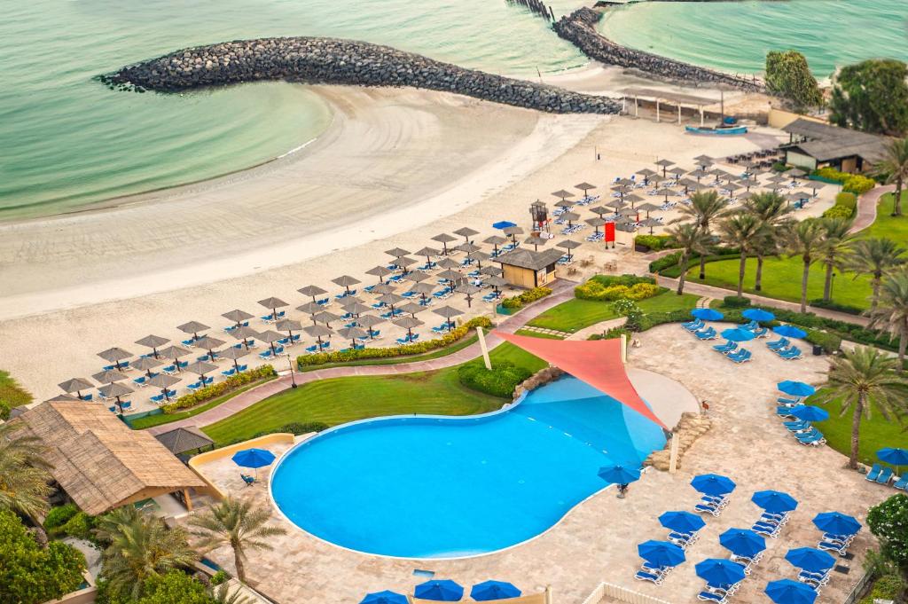 an aerial view of the beach and the resort at Coral Beach Resort Sharjah in Sharjah