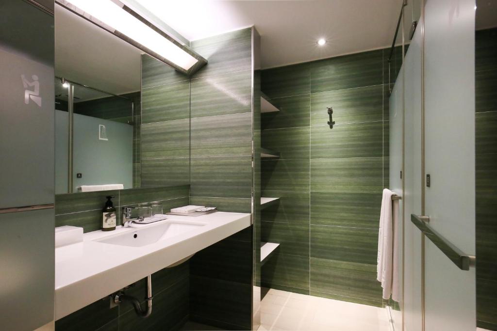 a bathroom with a sink and a shower at Dandy Hotel - Tianmu Branch in Taipei