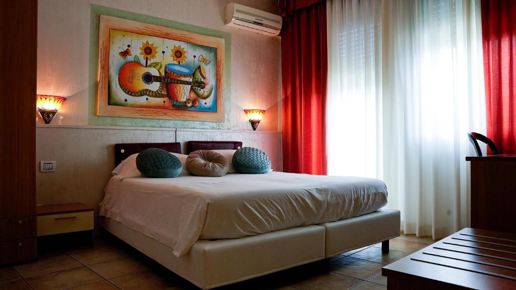a bedroom with a bed with two pillows on it at Florivana Boutique Hotel Ristorante in San Pietro in Cariano