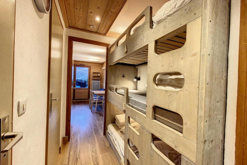 a room with bunk beds in it with a wooden wall at Rare pearl with incredible views in Les Houches