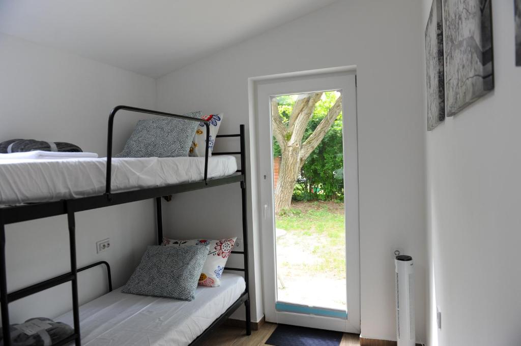 a bedroom with two bunk beds and a doorway at Cozy little hideaway in Balatonfüred