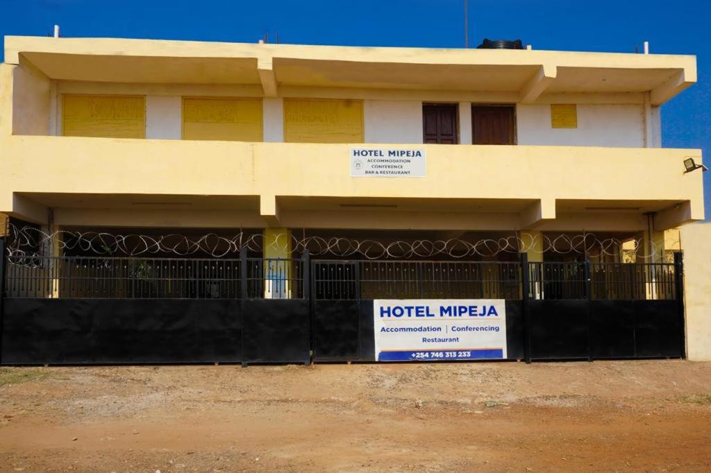 a building with a sign in front of it at Mipeja Hotel in Busia