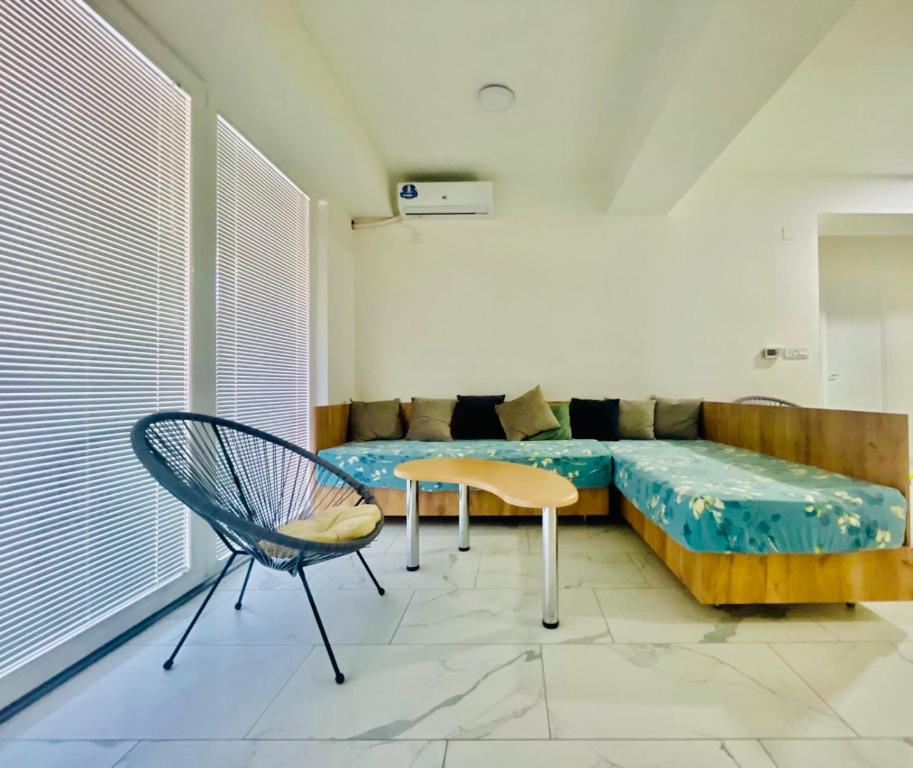 uma sala de estar com um sofá e uma cadeira em Skopje Boutique Apartments em Skopje