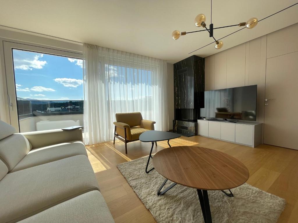 a living room with a couch and a table at Gega Apartments in Gjakove