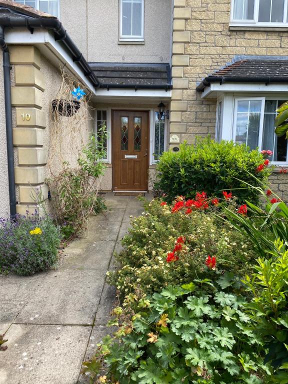 a house with a brown door and some flowers at Caledonia House in Rosyth