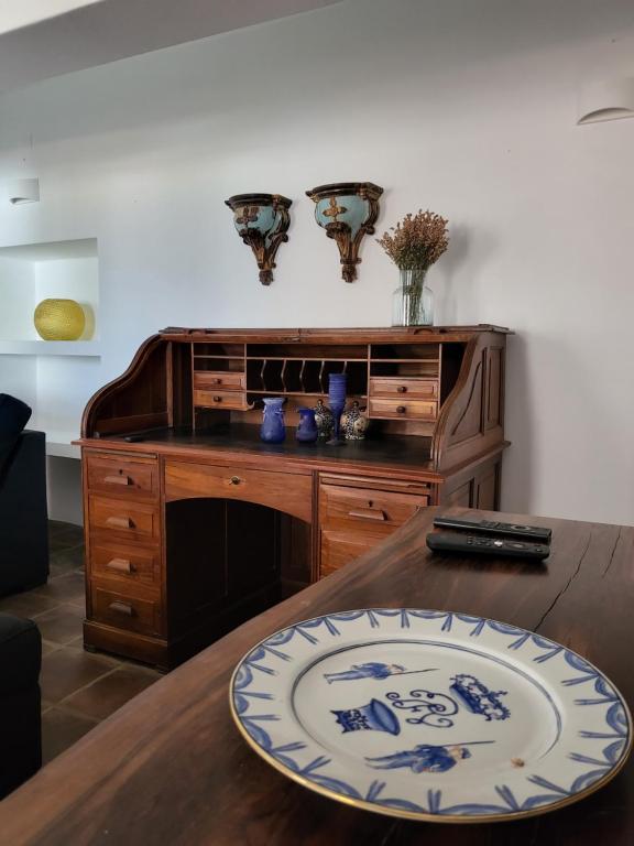 a wooden table with a plate on top of it at Solar de Arrayollos by PURUS in Arraiolos