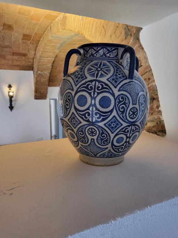 a blue and white vase sitting on a table at Solar de Arrayollos by PURUS in Arraiolos