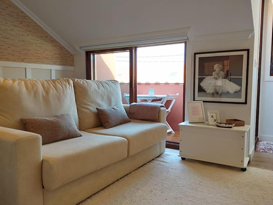 a living room with a couch and a table at MC LAGOS, Bueu in Pontevedra